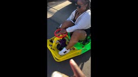 Drift kart mishap: lady takes a tumble uphill