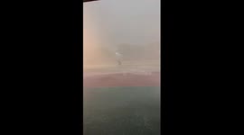 Students battle across sports field amid heavy rainfall in China
