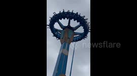 Tourists left hanging upside down in mid-air as amusement swing ride grinds to halt in southern China