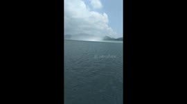 Fisherman sails perilously close to waterspout tornado