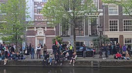 People waving the Palestinian flag and chanting anti police slogans at a University of Amsterdam campus in Amsterdam, Netherlands