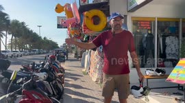 American, 57, gives out free helmets to motorcycle riders on notoriously unsafe Thai roads
