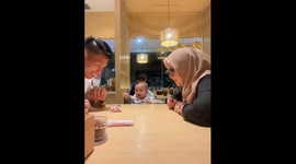 Joyful interaction: parents engage baby with car toy