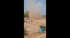 Dust devil tornado damages worker's shack on building site