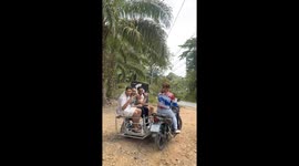 Motorcycle sidecar topples over with three tourists inside