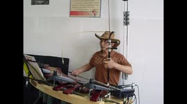 Teacher plays multiple instruments simultaneously to his class