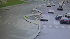 Strong wind moves fence in the middle of a road