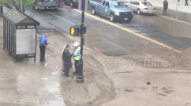 Springfield, MA Water Main Break/ Sinkhole  May 4, 2016 2:16 Elderly Couple Trying to cross the Street . Authorities tell them they cannot. See another video of authorities leading the couple across the street through another location.