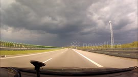 Sun on road, dark sky above