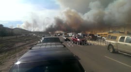 Footage of large amounts of cars driving away from Fort McMurray fire