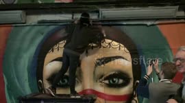 Graffiti artist Miss Hazard finishes off mural at Leake Street Tunnel - London
