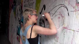 Graffiti artist Thunder**** paints Leake Street Tunnel wall - London