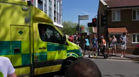 Ambulance rushes to help a runner during a half marathon in London on the hottest day of the year