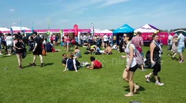 Runners relax in the sunshine at the finish line of the Hackney Half Marathon