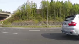 BMW driver on his mobile photo his child in the back M50 Dublin Ireland