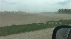 Dust cloud rolls across Minnesota field