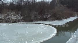 Perfect ice circle slowly turns on Russian river