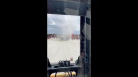 Dust devil whirls through vehicle yard in Savannah, US