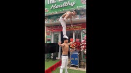 Street circus performers showcase impressive balancing act in Hanoi, Vietnam