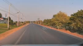 Motorcycle rider crashes but leaps to his feet to avoid being struck by oncoming cars
