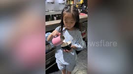 Little girl shows off her impressive latte art