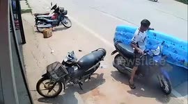 Motorcycle rider carries inflated paddling pool on his head