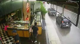 Pick up truck skids on wet road and crashes into shop