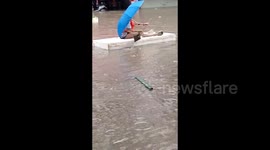 Chinese residents navigate flooded street using DIY foam boats amid torrential rain chaos