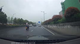 Helping a fallen motorcyclist on slippery road