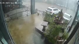 Shop sign collapses in hail of sparks during storm