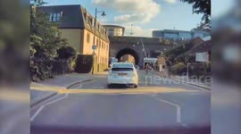 Moment lamppost falls on road - narrowly missing Tesla