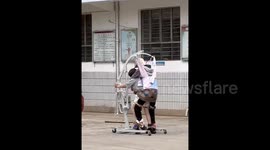 Inspiring Chinese mother crafts recovery apparatus to aid paralysed son in walking practice