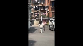 Beginner skateboarder's struggle: downhill descent ends in tumble with friend's help