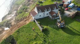 Farmhouse left hanging over perilous cliff edge demolished