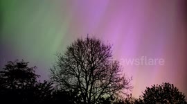 Timelapse Aurora Borealis The Northern Lights ablaze with colours over a tree in Wirksworth in the Derbyshire Dales 10/5/2024