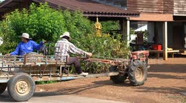 A Thai farmer and his wife set off to work on their farm on a Kubota tractor, in Phetchabun, Thailand.