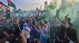 Youth Demand activists deploy dozens of smoke flares as they block Waterloo Bridge to highlight situation in Rafah