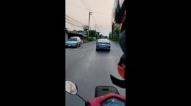 Hero motorcycle rider stops car with cat riding on roof