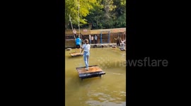 China: Girl on a bungee over the water
