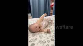 China: Baby rolls over on his own for the first time