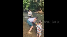 China: Man Rescues Child From Rapids In Qujing, Yunnan