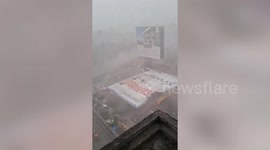 Officials come to rescue after hoarding collapses due to strong wind in western india