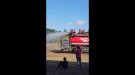 Rainbow appears on football field while truck waters the grass