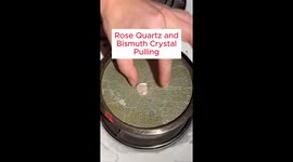 A bismuth crystal is made with a piece of rose quartz and pulled out of molten bismuth.