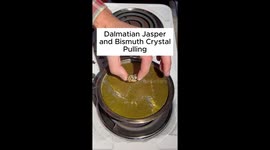 A bismuth crystal is made with a piece of Dalmatian Jasper and pulled out of molten bismuth