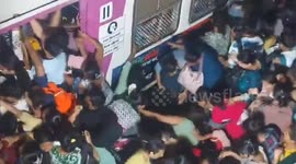 India: Commuters pile into train as Maharashtra storm causes chaos