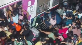 Locals pile into train carriage as Mumbai storm sparks chaos