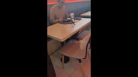 Tourist shares breakfast with cheeky sparrow at Chinese airport