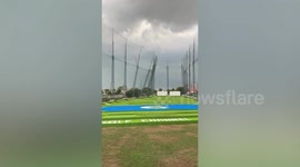 Violent winds blow over golf driving range fence in Bangkok
