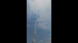 Tourists watch homemade rockets being launched for Thai festival